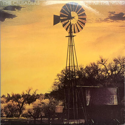 The Crusaders : Free As The Wind (LP, Album, RE, Glo)