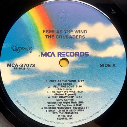 The Crusaders : Free As The Wind (LP, Album, RE, Glo)