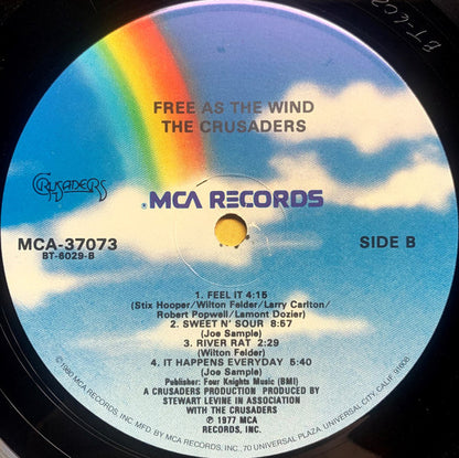 The Crusaders : Free As The Wind (LP, Album, RE, Glo)